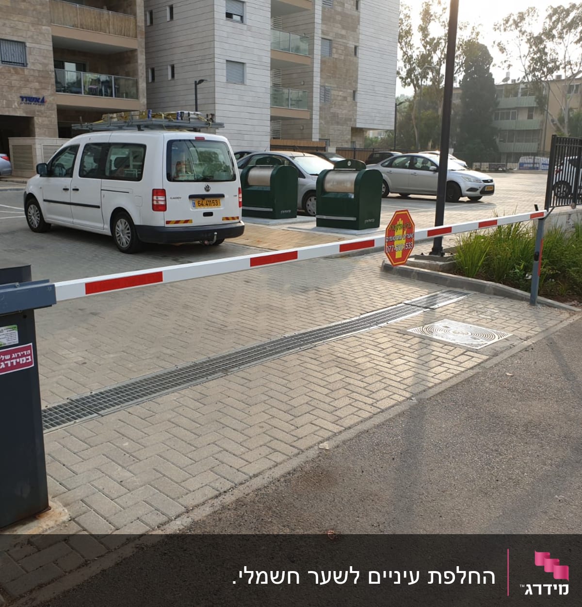 מחסום חשמלי בכניסה לחניון עם שלט עצור